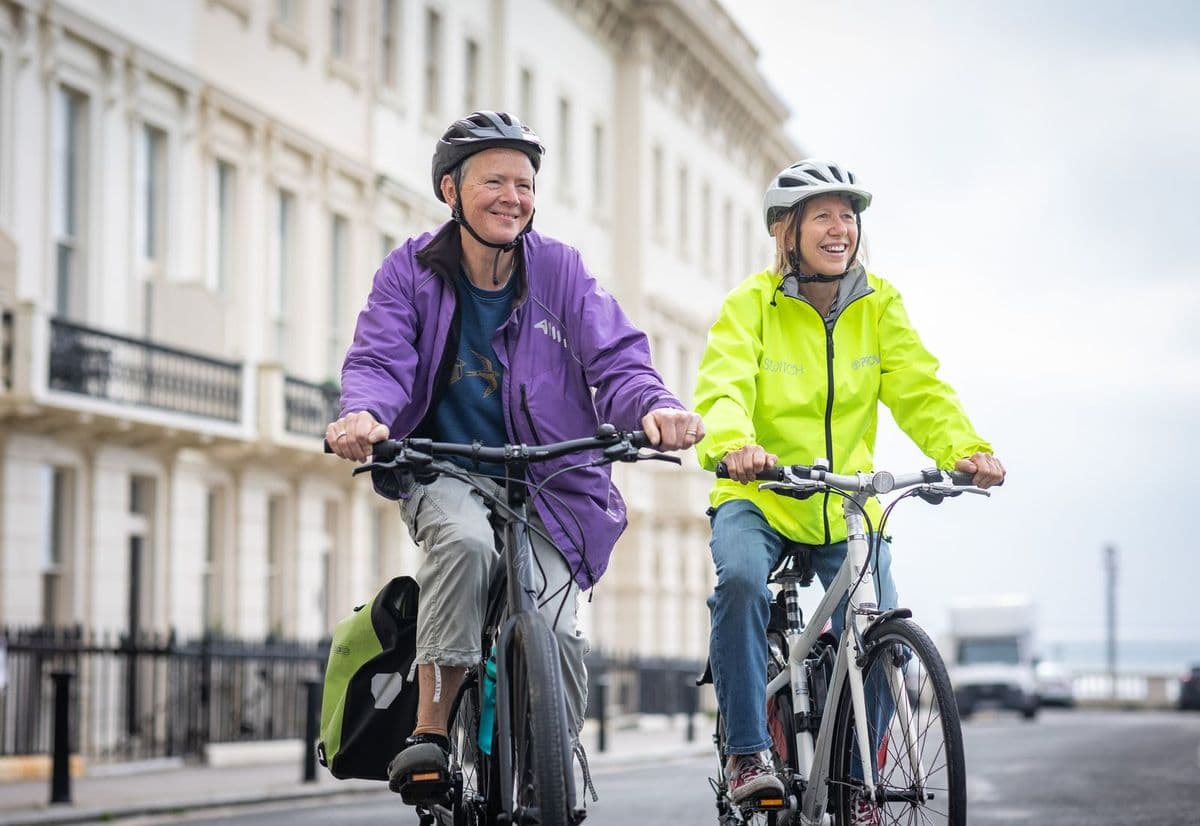 An older couple riding bikes in the city