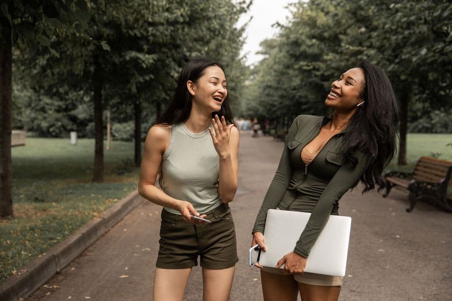 Two friends laughing on a walk